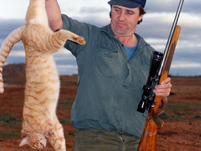 Kangaroo shooter Peter Absolom with a wild feral cat he shot.