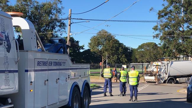 A heavy duty two truck arrives at the site of an incident where a garbage truck has got stuck in a sinkhole in Namona St, Narrabeen. Picture: Jim O'Rourke.