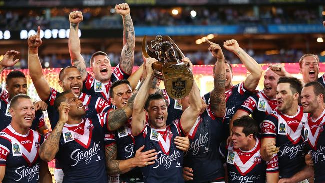 SYDNEY, AUSTRALIA - OCTOBER 06: Roosters captain Anthony Minichiello holds aloft the Provan-Summons Trophy with teammates after victory during the 2013 NRL Grand Final match between the Sydney Roosters and the Manly Warringah Sea Eagles at ANZ Stadium on October 6, 2013 in Sydney, Australia. (Photo by Matt King/Getty Images)