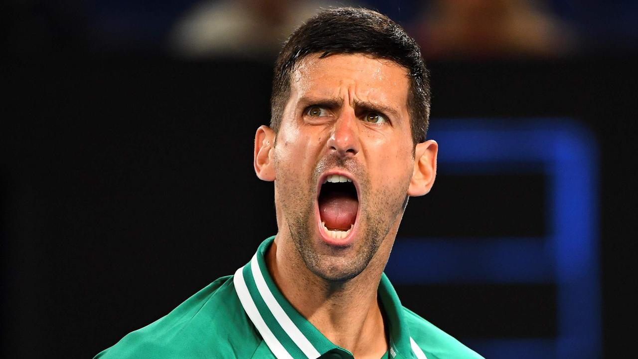 Serbia's Novak Djokovic reacts on a point against Taylor Fritz of the US during their men's singles match on day five of the Australian Open tennis tournament in Melbourne on February 12, 2021. (Photo by William WEST / AFP) / -- IMAGE RESTRICTED TO EDITORIAL USE - STRICTLY NO COMMERCIAL USE --