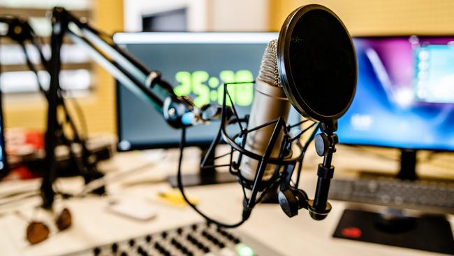 Microphone and mixer at the radio station studio broadcasting news. iStock