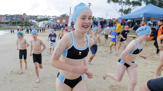 Amy Gooley runs to the starting line. The second day of the Schools Triathlon Challenge at Bellerive Beach.