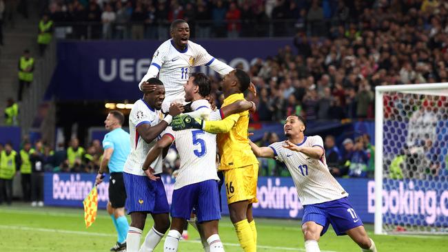 France's players celebrate after winning the UEFA Euro 2024 quarter-final. (Photo by FRANCK FIFE / AFP)