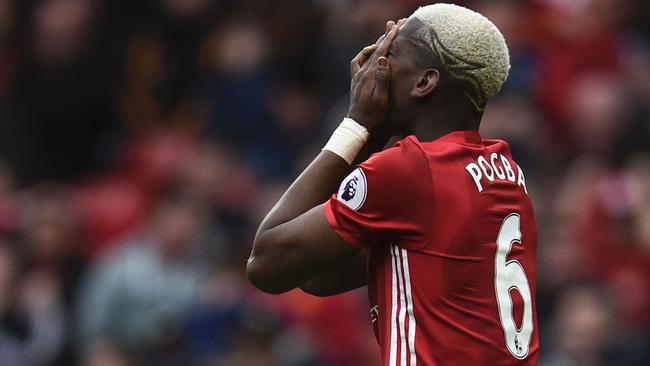 Manchester United's French midfielder Paul Pogba reacts after failing to convert a late chance during the English Premier League football match between Manchester United and Bournemouth at Old Trafford in Manchester, north west England, on March 4, 2017. The game finished 1-1. / AFP PHOTO / Oli SCARFF / RESTRICTED TO EDITORIAL USE. No use with unauthorized audio, video, data, fixture lists, club/league logos or 'live' services. Online in-match use limited to 75 images, no video emulation. No use in betting, games or single club/league/player publications. /