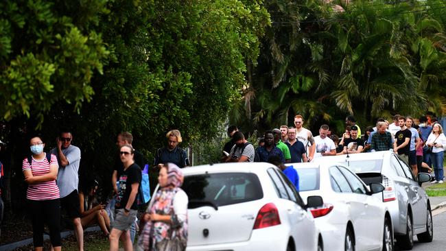 People are seen in a long queue outside a Centrelink office in Brisbane. Picture: AAP/Dan Peled