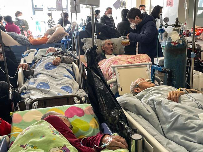 Patients on stretchers are seen at Tongren hospital in Shanghai. A senior doctor at Shanghai's Ruijin Hospital has said 70 percent of the megacity's population may have been infected with Covid-19. Picture: AFP