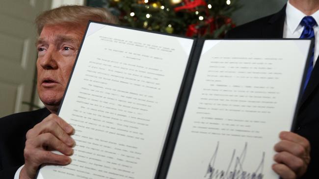 President Donald Trump holds up a proclamation to officially recognize Jerusalem as the capital of Israel, in the Diplomatic Reception Room of the White House, Wednesday, Dec. 6, 2017, in Washington. (AP Photo/Evan Vucci)