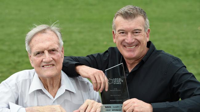 Croydon's Roger O'Brien, 84, is presented with the 'Local Sports Stars 2018 National Winner Service To Sport' award by Ten News sports presenter Stephen Quartermain. Picture: Steve Tanner