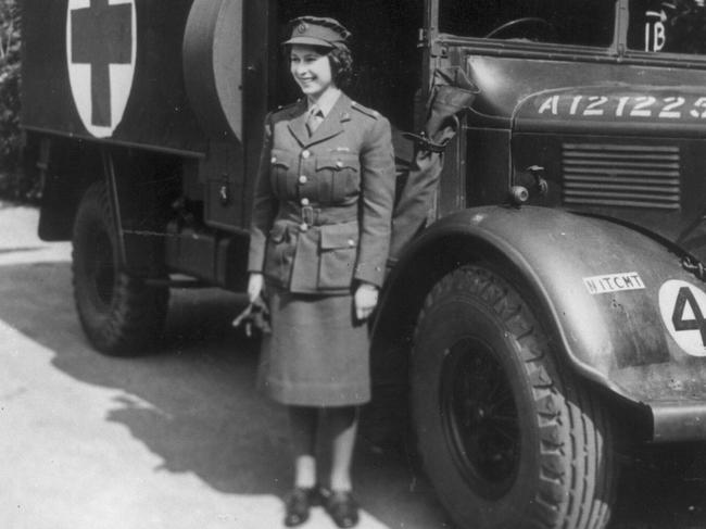 Princess Elizabeth stands in front of an army truck she learned to drive during World War II.