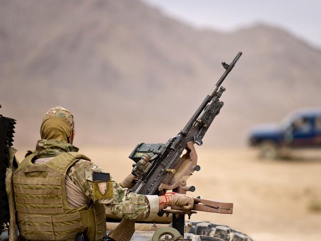 Photographer: SGT Neil RuskinCaption: A soldier from the Special Operations Task Group mans the gun on a convoy to the Northern Kandahar region for a disruption operation. Mid Caption: The SOTG and partnered Afghan police of the Provincial Response Company conducted the operation to secure the northern approaches of Kandahar province and disrupt insurgent activities.During the operation Australian soldiers cleared paths through areas heavily sown with IEDs to attack insurgents in their safe havens.Afghan police and SOTG members warned locals to avoid areas where they had identified IEDs.Over the course of the operation, SOTG elements destroyed 16 IEDs.A large amount of materiel and components for the construction of IEDs were also recovered by the force element. The items were destroyed to ensure the safety of Afghan civilians, Afghan National Security Forces, Coalition and ISAF forces.