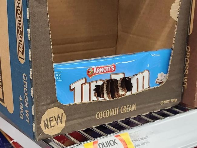 An outraged Coles customer has shared a photo of a Tim Tam packet seemingly ravaged by pests. Picture: Reddit