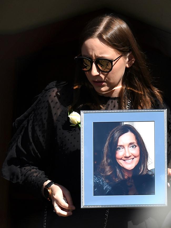 Sarah Ristevski leaves her mother’s funeral holding a framed photo of her. Picture: Nicole Garmston