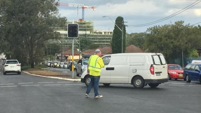 "Noodle man" - a civilian armed with a pool noodle - directs traffic at the Kingsway and Sylvania Rd in Gymea. Picture: Supplied