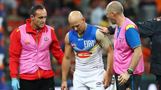 Gold Coast Suns' Gary Ablett is consoled by former premiership teammate Steve Johnson after the GWS Giants had huge win over Gold Coast Suns at Spotless Stadium. Picture. Phil Hillyard