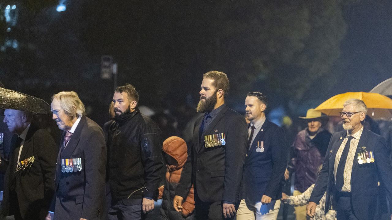 Jason Hurst (centre) in the pre-dawn march to the Anzac Day Toowoomba Dawn Service, Tuesday, April 25, 2023. Picture: Kevin Farmer