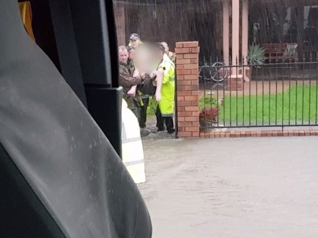 Police use a tipper truck to evacuate families in "very extreme circumstances in which the risk to the lives of Queenslanders was imminent". Picture: Supplied