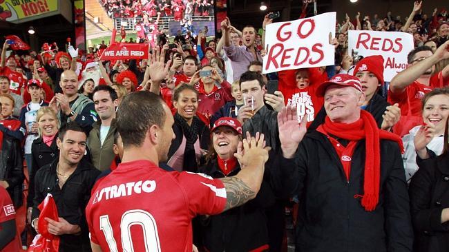 Quade Cooper celebrates a win Reds fans at Suncorp Stadium.