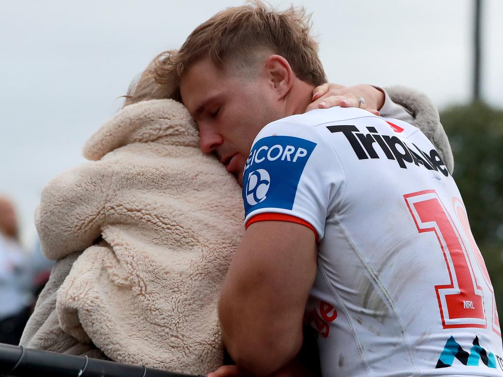 Jack de Belin in a family hug with partner Alyce Taylor.