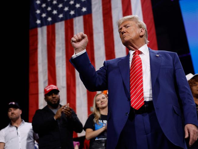 ATLANTA, GEORGIA - OCTOBER 15: Republican presidential nominee, former U.S. President Donald Trump raises his fist after delivering remarks during a campaign rally at the Cobb Energy Performing Arts Centre on October 15, 2024 in Atlanta, Georgia. With early voting starting today in Georgia both Trump and Democratic presidential nominee, Vice President Kamala Harris are campaigning in the Atlanta region this week as polls show a tight race.   Kevin Dietsch/Getty Images/AFP (Photo by Kevin Dietsch / GETTY IMAGES NORTH AMERICA / Getty Images via AFP)