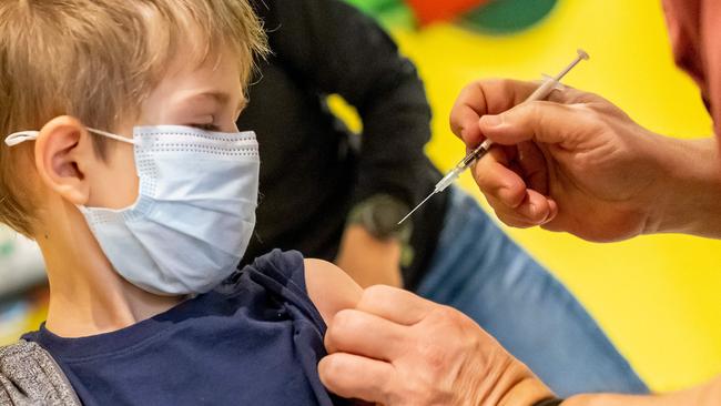 A doctor inoculates 5-year-old Phillip with the first dose of the Pfizer-BioNTech vaccine against the coronavirus. Photo by HANNIBAL HANSCHKE / AFP