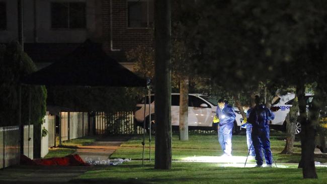 Forensics officers documenting the crime scene on Budgeree road Toongabbie Picture: Steve Tyson