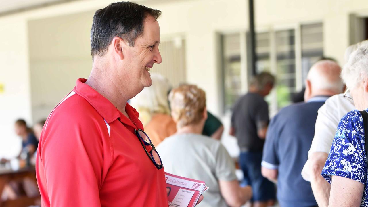 Jason Hunt speaks with early voters at the Caloundra Cricket Club. Picture: Patrick Woods.