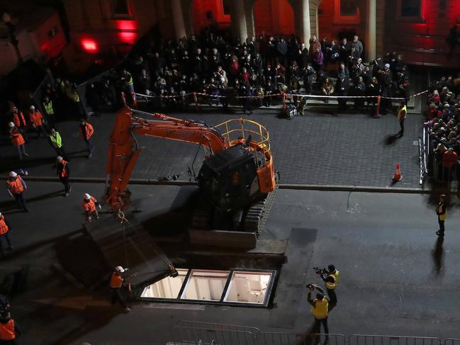 The lid for Mike Parr’s chamber is moved back into place before the road surface was resealed.. Picture: NIKKI DAVIS-JONES