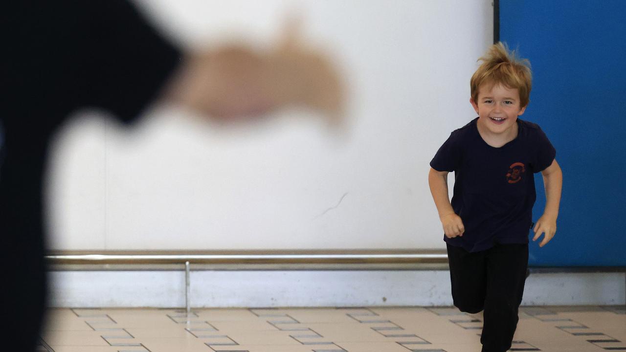 Torvi Phillips runs to his dad Scottie at Brisbane International Airport. Picture: Adam Head