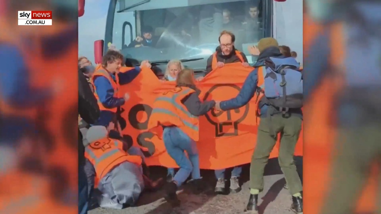 Bus ploughs through climate protesters in UK