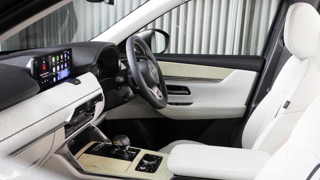 Inside the Mazda CX-60 with the optional $2000 Takumi pack which adds white nappa leather seat trim, maplewood console and a suede-style dash finish with special stitching.