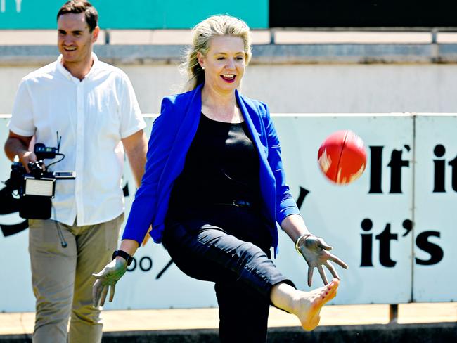 Former Sports Minister Senator Bridget McKenzie kicks the footy with local players after announcing the new $100m community grants program.