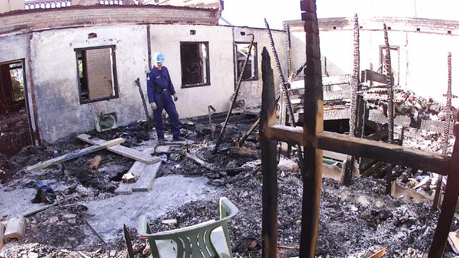 Fireman Darryl Livermore inspects remains of the dormitory on the upper level of Palace Backpackers Hostel after the fatal fire. Picture: Anthony Weate.