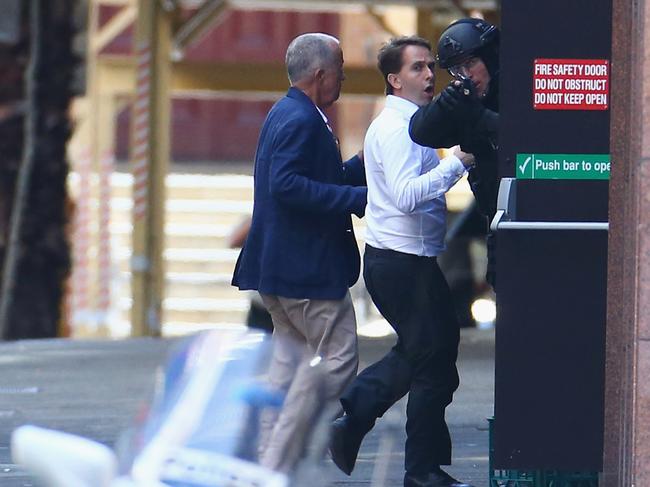 John O’Brien and Stefan Balafoutis run to safety outside the Lindt Cafe. Picture: Don Arnold