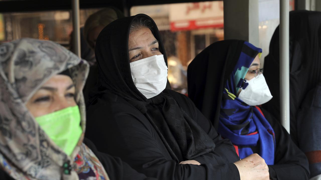 Commuters wear masks to help guard against the Coronavirus on a public bus in downtown Tehran, Iran.