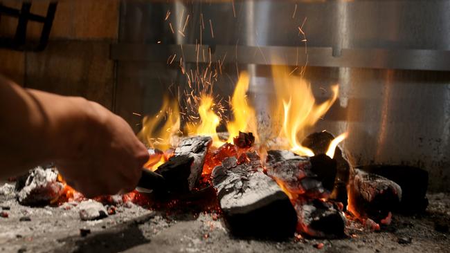 The custom made fire pit at  Burnt Ends Kitchen and Bar. Picture: AAP/Steve Pohlner
