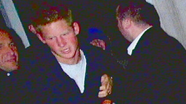 Prince Harry being grabbed by a minder after clashing with photographer Chris Uncle in October 2004.