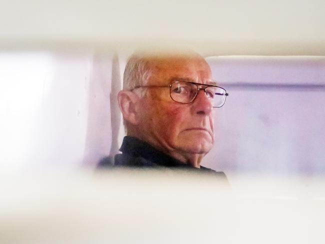 Roger Rogerson inside a police truck being taken into Bankstown Court to face charges relating to the murder of Jamie Gao. Picture: Craig Greenhill