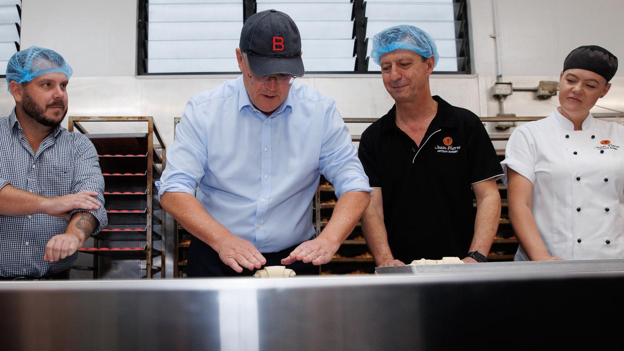 The Prime Minister in action while visiting the Jean-Pierre Wholesale Artisan Bakery in Townsville. Picture: Jason Edwards