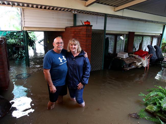 Kellee Wilson and husband Steven stand in the rising water that has flooded the lower level of their Bellevue Rd home in Regentville. Picture: Toby Zerna