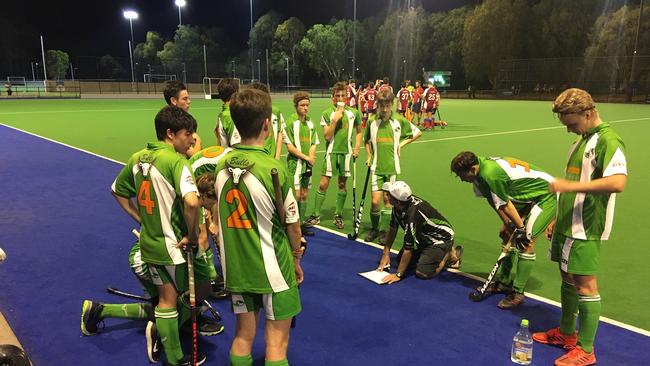 Bulimba players listen intently to the halftime address.