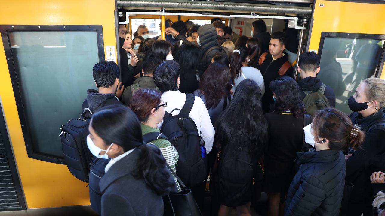 People pushed their way into overcrowded carriages at Strathfield train station on Wednesday morning. Picture: John Grainger