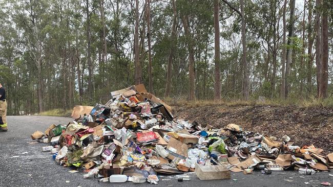 Recyclable rubbish dumped on the road after smoke was seen billowing from the back of a Gympie garbage truck at North Deep Creek on Thursday morning. Photo: Kristen Camp