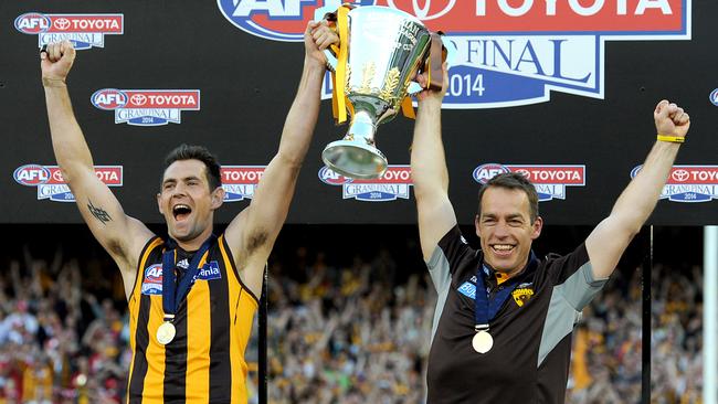 Hawthorn coach Alastair Clarkson and Luke Hodge celebrate the 2014 premiership win. Picture: AAP Image/Joe Castro