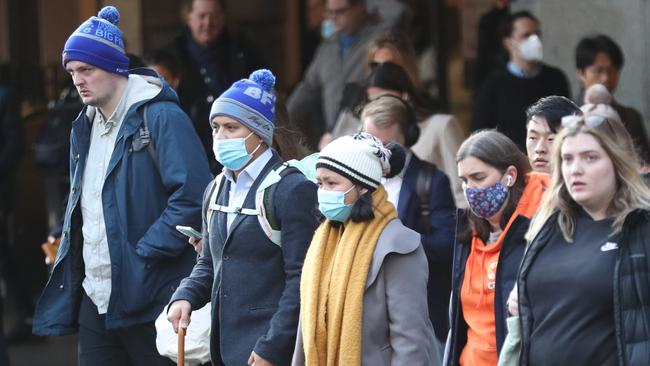 Melburnians rugging up for the conditions on Tuesday. Picture: NCA NewsWire / David Crosling