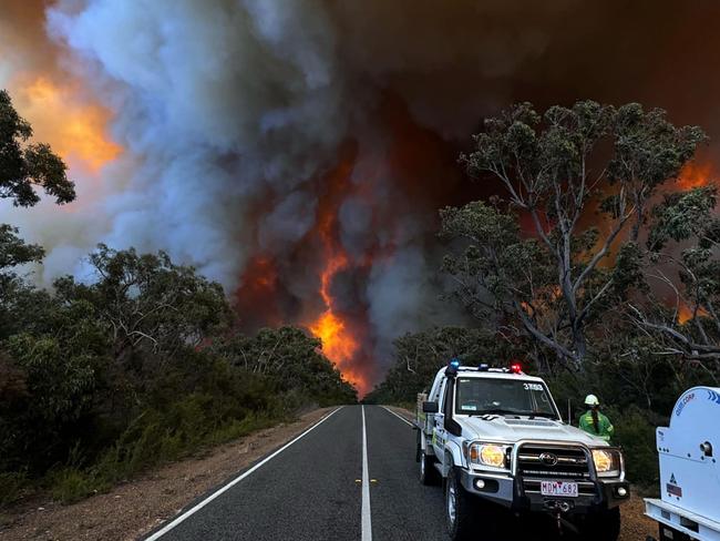 This undated handout image received on December 26, 2024 from the State Control Centre of the Victoria Emergency Services shows officials on a road near a bushfire in the Grampians National Park in Australia's Victoria state. (Photo by Handout / STATE CONTROL CENTRE - VICTORIA EMERGENCY SERVICES / AFP) / RESTRICTED TO EDITORIAL USE - MANDATORY CREDIT "AFP PHOTO /  STATE CONTROL CENTRE - VICTORIA EMERGENCY SERVICES" - NO MARKETING - NO ADVERTISING CAMPAIGNS - DISTRIBUTED AS A SERVICE TO CLIENTS