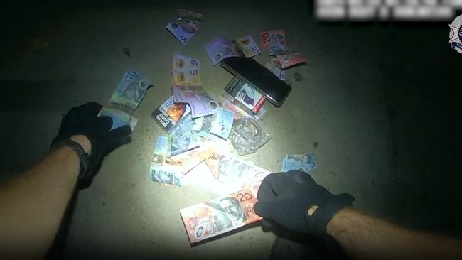 A Task Force Guardian officer turns out the pockets of an offenders charged with stealing a taxi from Lake St last week. Picture: Queensland Police