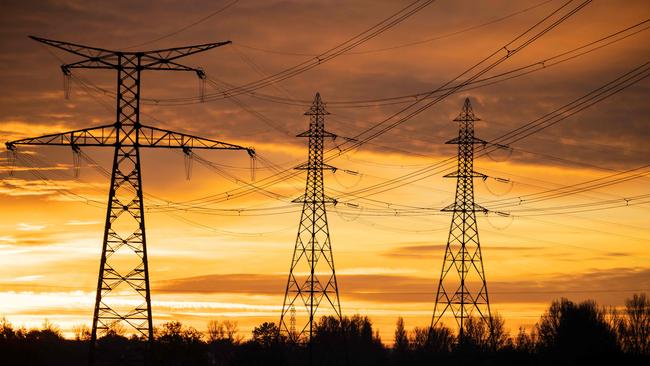 This photograph taken on December 6, 2022, shows the poles of a very high voltage power line in Verfeil, southwestern France. - France may face "some days" this winter when insufficient electricity supply could mean power cuts, the head of French energy regulator RTE said on December 1, 2022, as the government briefed local authorities on how to manage any possible outages. (Photo by Lionel BONAVENTURE / AFP)