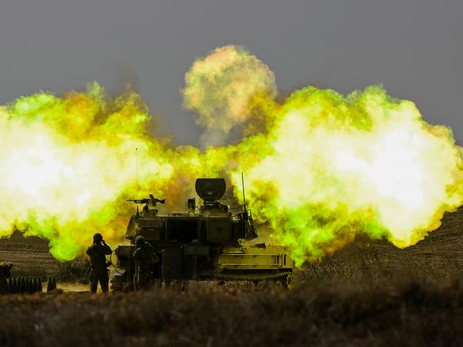 An IDF Artillery soldier covers his ears as a shell is fired towards Gaza near Netivot, Israel. Picture: Getty Images