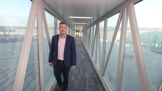 Former Queensland Airports Limited CEO Chris Mills tries out a new air bridge at the terminal expansion. Picture: Glenn Hampson.