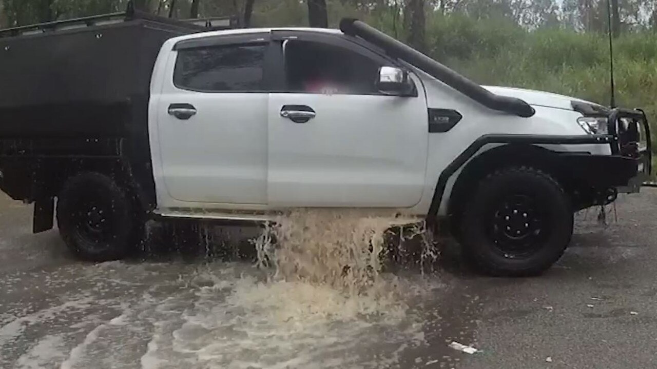 Water pours from the car after it was pulled out of water on Tuesday.